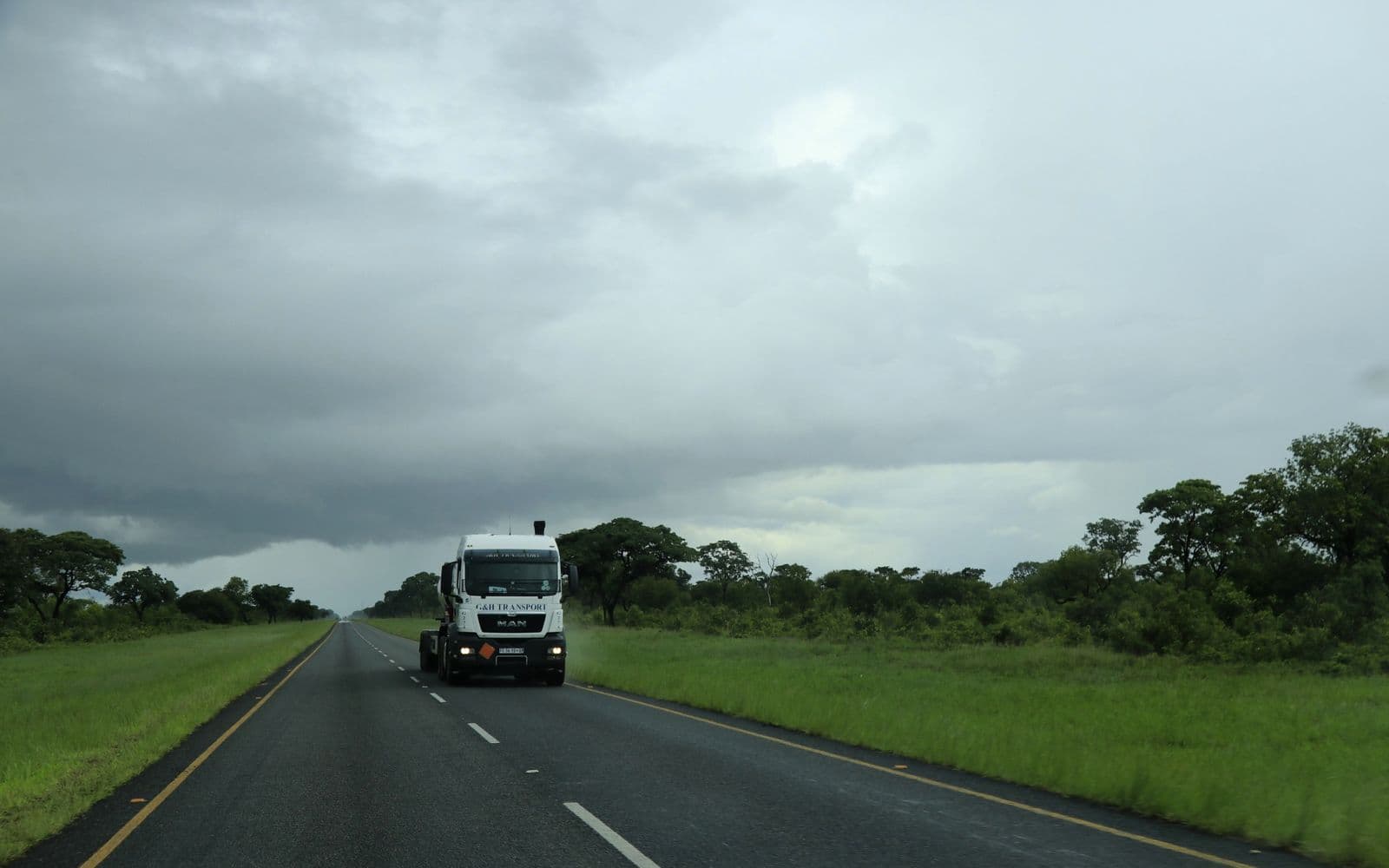 A cargo truck travelling an open road.